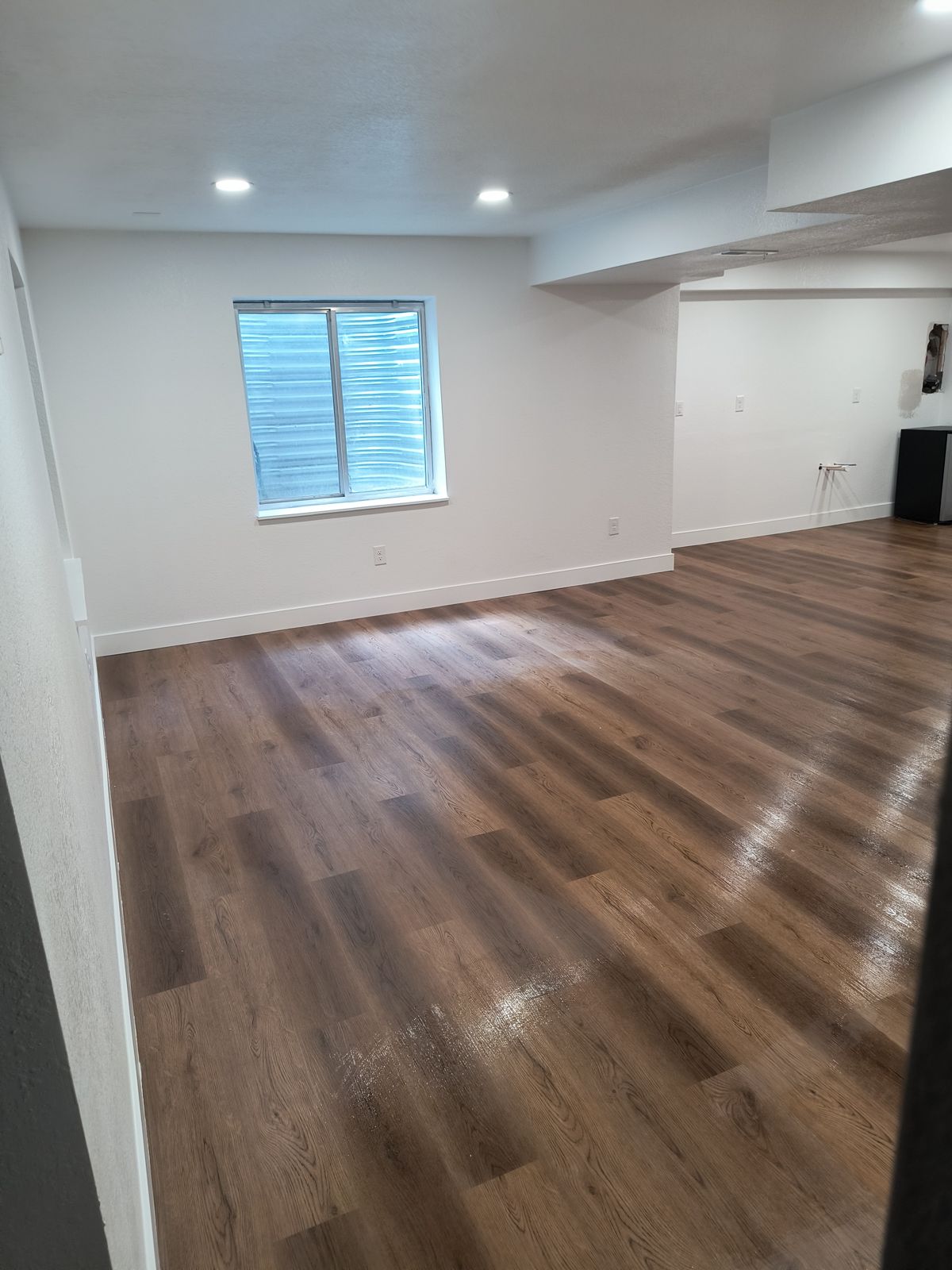 Basement remodel with luxury vinyl plank flooring in Thornton, CO