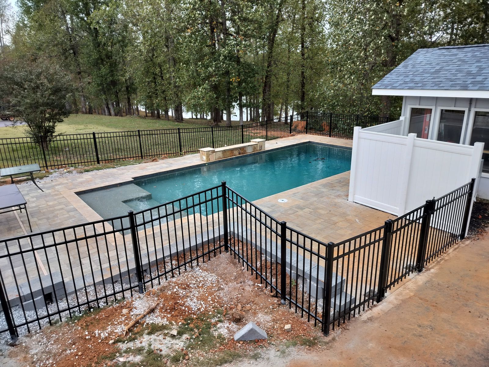 Pool deck pavers with aluminum fence